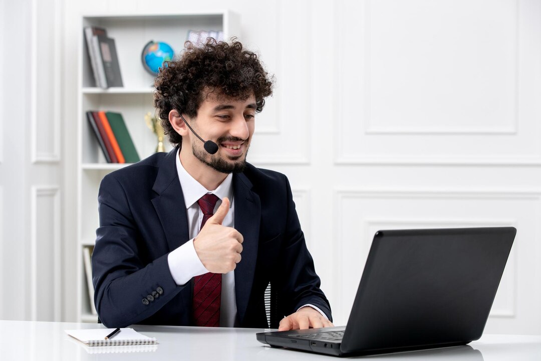 Man with headphones working on a laptop